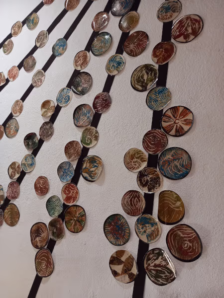 Foto de una instalación sobre pared con líneas rectas y círculos grabados