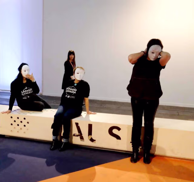 Foto de performance con personas enmascaradas